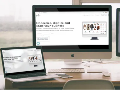 The Goodpix website shown on a desktop monitor and a laptop